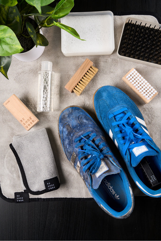 dirty and clean pair of blue adidas samba sneakers with reshoevn8r cleaning products